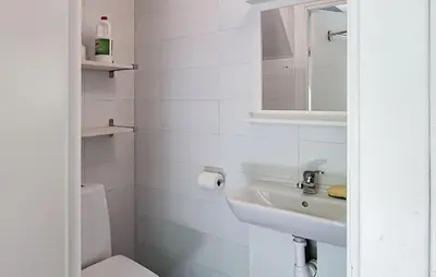 a white bathroom with a sink and a toilet at Cozy Home In Stongfjorden With House Sea View in Stongfjorden