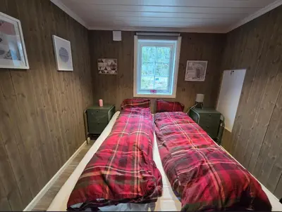 a room with three beds in a room with a window at Family-friendly cabin at Høgevarde! in Flå