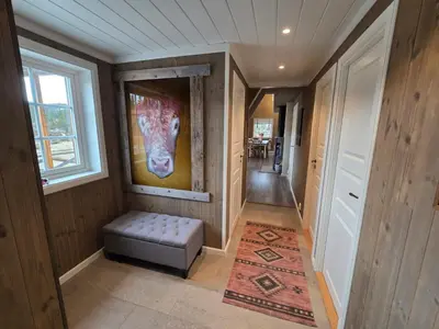 a hallway with a painting of a horse on the wall at Family-friendly cabin at Høgevarde! in Flå