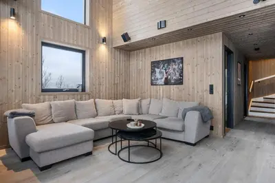 a living room with a couch and a table at Vestbyvegen 34A By Vacation Trysil in Trysil