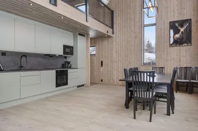 a kitchen and dining room with a table and chairs at Vestbyvegen 34A By Vacation Trysil in Trysil