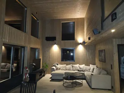 a living room with a white couch and a tv at Vestbyvegen 34A By Vacation Trysil in Trysil