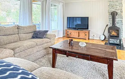 a living room with a couch and a coffee table at Beautiful Home In Kvammen With House A Panoramic View in Kvammen