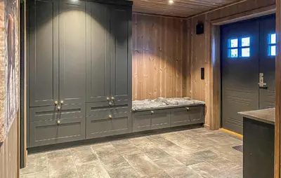 a locker room with gray cabinets and a bench at Lovely Home In Bjorli With Sauna in Bjorli
