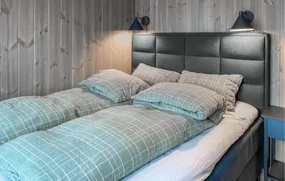 a bed with two pillows on top of it at Lovely Home In Bjorli With Sauna in Bjorli