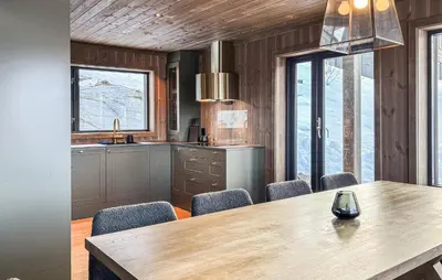 a kitchen with a wooden table and chairs at Lovely Home In Bjorli With Sauna in Bjorli