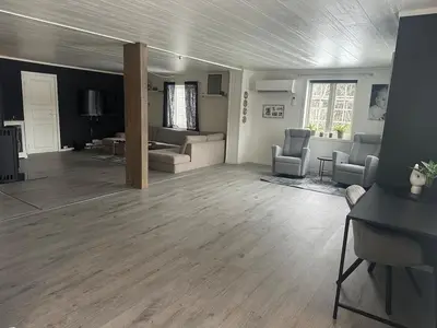 a living room with couches and chairs in a room at Bolig sentralt på Røros in Røros
