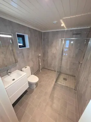a bathroom with a shower and a toilet and a sink at House with great location in Trysil