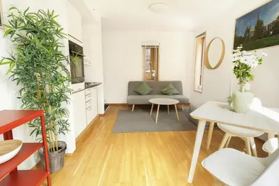 a living room with a couch and a table at Stylish apt 2nd floor city centre in Trondheim