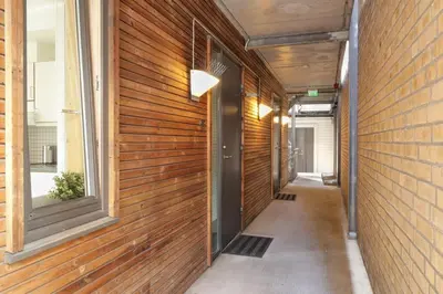 a hallway of a building with wooden walls and windows at Stylish apt 2nd floor city centre in Trondheim
