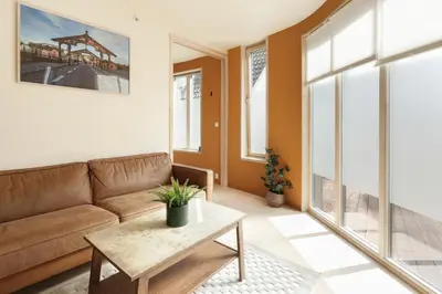 a living room with a couch and a table at Elegant 1-Bed Apt in City Centre in Trondheim