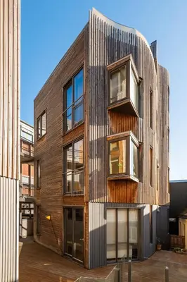 an office building with a wooden facade at Elegant 1-Bed Apt in City Centre in Trondheim