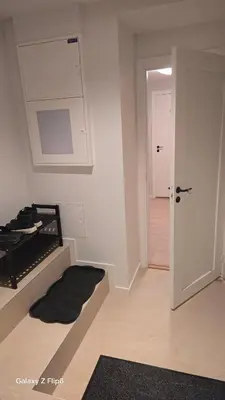 a white room with a door and a hallway at Apartament Vigra Fjord in Synes