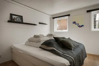 a bedroom with a bed with pillows on it at 3 soverom, sentralt i Bergen og moderne bad in Bergen