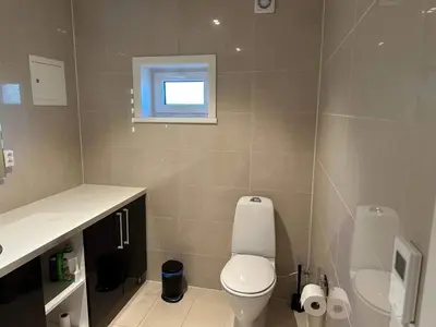 a bathroom with a toilet and a sink and a window at 4 star holiday home in Eidsvåg in Eidsvåg