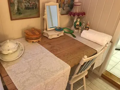 a room with a table with a mirror and a table with a chair at Near Trolltunga and centre of Odda in Odda