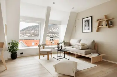 a living room with a couch and a large window at Relaxed apartment with a view in Bergen