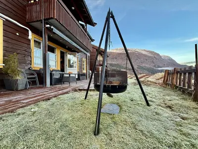 a swing in front of a house at Unique view! Modern apartment with sauna in Vossevangen