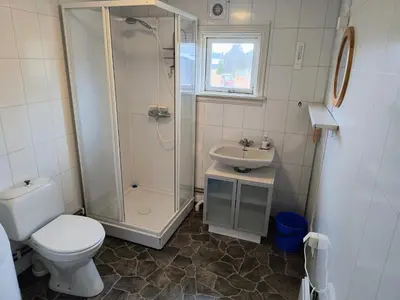 a bathroom with a shower and a toilet and a sink at Ullabu in Gol