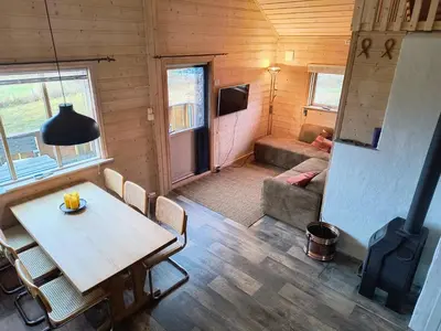 a room with a table and chairs and a living room at Ullabu in Gol