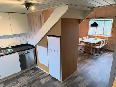 a kitchen with a table and a dining room at Ullabu in Gol