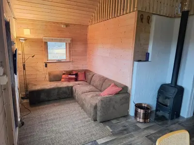 a living room with a couch and a stove at Ullabu in Gol