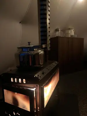 a stove with a pot sitting on top of it at Torshaug glamping in Trondheim