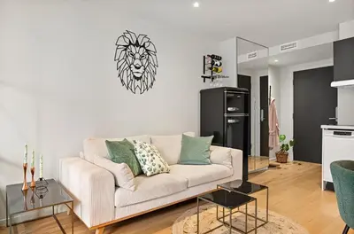 a living room with a couch with a lion on the wall at Studio apartment in city center in Bergen