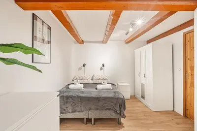 a bedroom with a bed in a room with white walls at Bergen city center Kalfaveien in Bergen