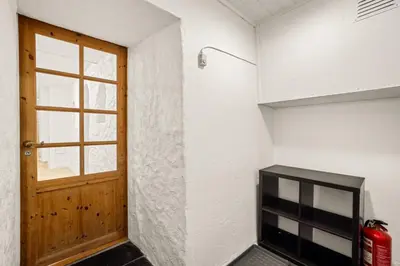 a room with a door and a window and a fire extinguisher at Bergen city center Kalfaveien in Bergen