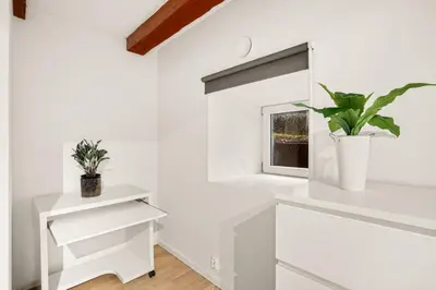 a white kitchen with white cabinets and a window at Bergen city center Kalfaveien in Bergen