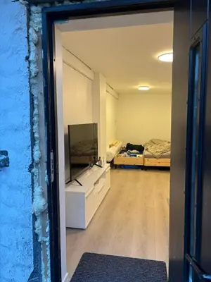 a room with a tv and a room with two beds at Family friendly apartment with parking in Bergen