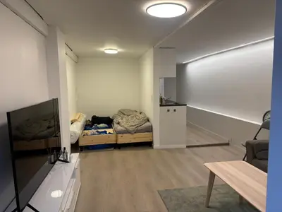a small room with a bed and a tv at Family friendly apartment with parking in Bergen