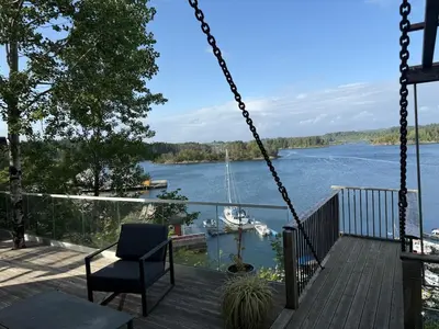 a swing on a deck with a view of a lake at Haven Fortress