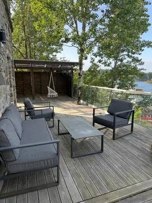 a deck with chairs and a couch and a swing at Haven Fortress