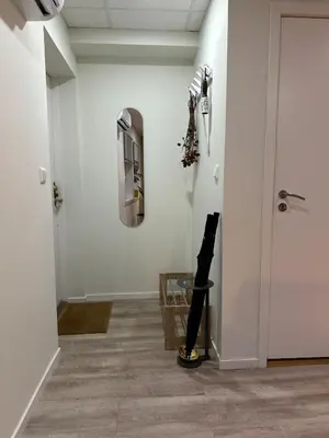 a hallway with a persons leg on the floor next to a wall at Tasteful apartment in Sogndal with parking in Sogndal