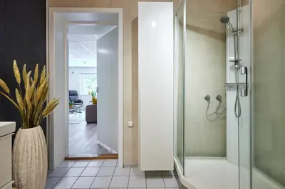a bathroom with a walk in shower and a toilet at Tasteful apartment in Sogndal with parking in Sogndal
