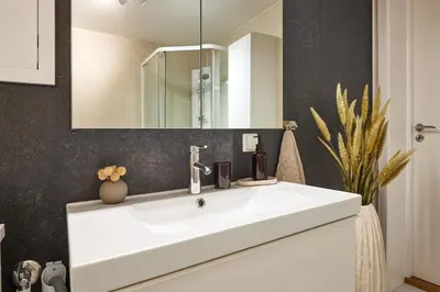 a bathroom with a white sink and a mirror at Tasteful apartment in Sogndal with parking in Sogndal