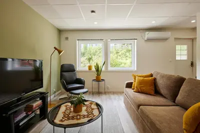 a living room with a couch and a tv at Tasteful apartment in Sogndal with parking in Sogndal