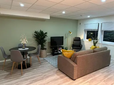 a living room with a couch and a table and a tv at Tasteful apartment in Sogndal with parking in Sogndal