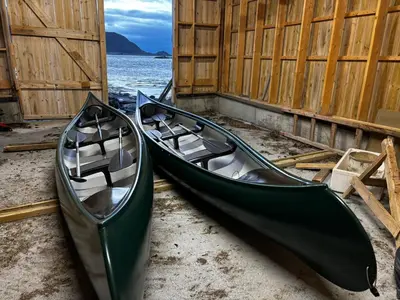 two green canoes parked next to the water at Unik og moderne hytte med utsikt mot havet 38 in Haram