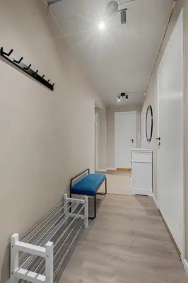 a hallway with a blue bench in a room at Apartment in idyllic Kristiansund in Kristiansund
