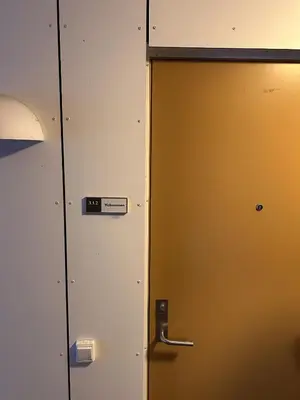 a door in a room with a sign on it at Convenient Bergen Stay with Easy Transport Connections in Bergen