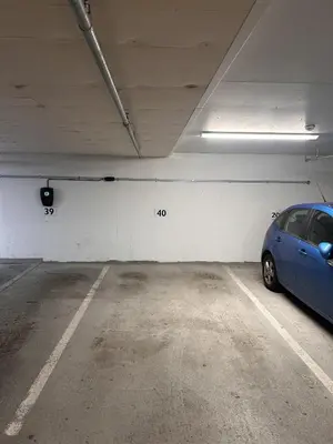 a parking garage with a blue car parked in it at Convenient Bergen Stay with Easy Transport Connections in Bergen