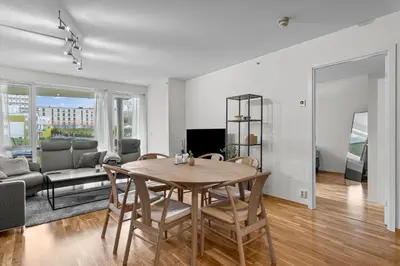 a dining room and living room with a table and chairs at Convenient Bergen Stay with Easy Transport Connections in Bergen