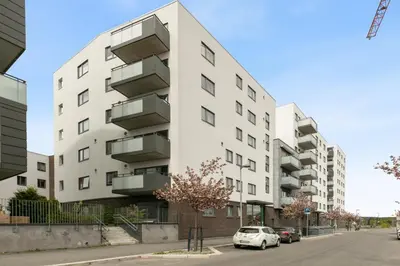 a white building with balconies on the side of a street at Modern apartment near Oslo in Lii