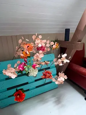 a wooden table with flowers on it at Authentic top floor pearl in the city Center in Ålesund
