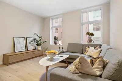 a living room with a couch and a table at Large apartment, central and quiet in Ålesund in Ålesund