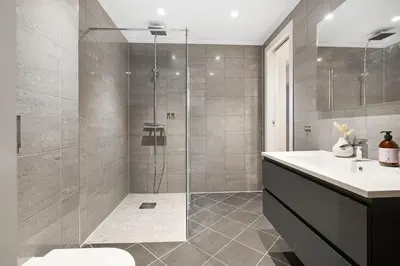 a bathroom with a shower and a toilet and a sink at Large apartment, central and quiet in Ålesund in Ålesund