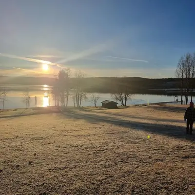 a person walking on a beach near a body of water at A house for rent in Osen, only 45 min from Trysil in Åmot